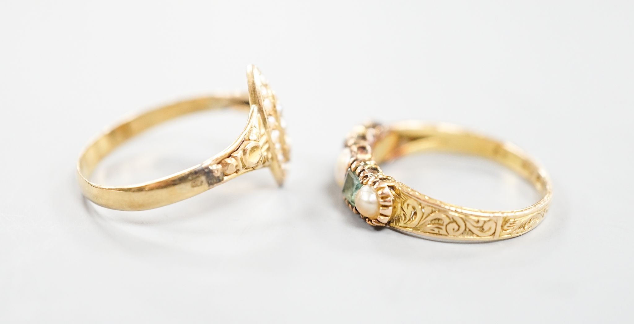 A Victorian 15ct gold, emerald and split pearl set five stone half hoop ring, size M, gross 1.9 grams and an early 20th century yellow metal and seed pearl set dress ring, size O, gross 1.7 grams.